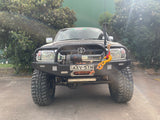 N60 Facelift Bullbar for 1997-2005 Toyota Hilux with satin black finish, integrated LED lights, and blinker/parkers, featured on Jocko's Hilux.